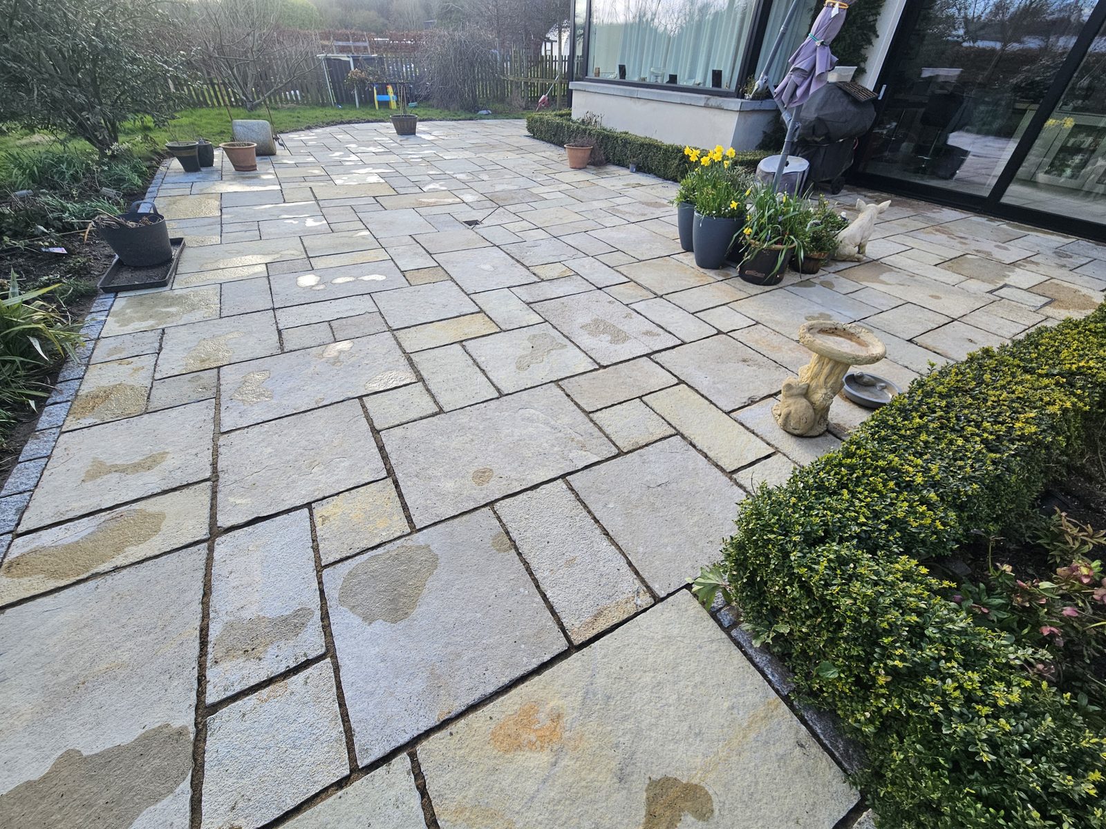 Bright sandstone patio cleaned and re-jointed