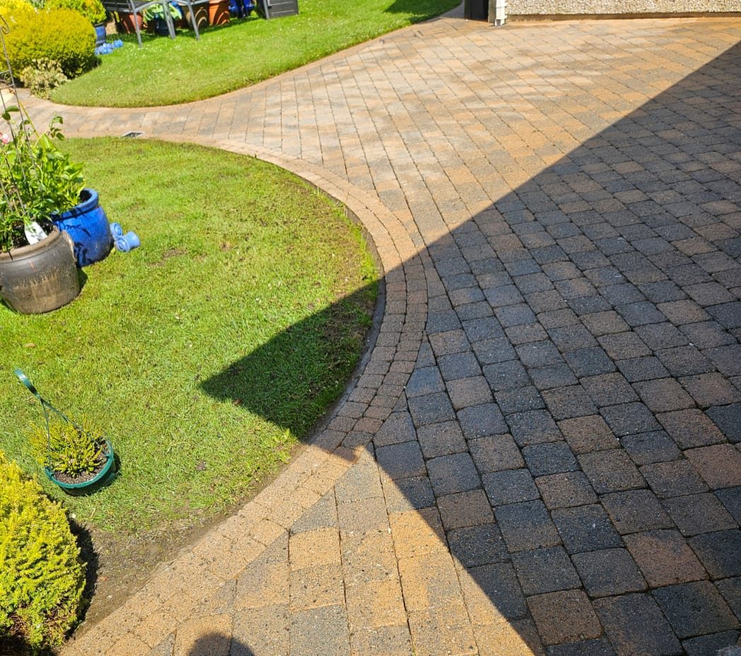 The same curved block paving driveway after cleaning — full colour mix restored