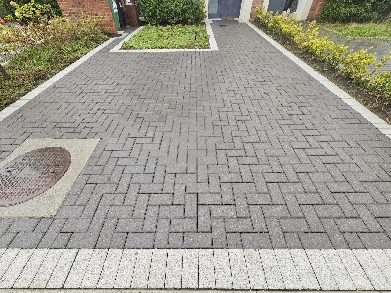 The same block paving driveway after cleaning, joints clear and blocks back to their original grey